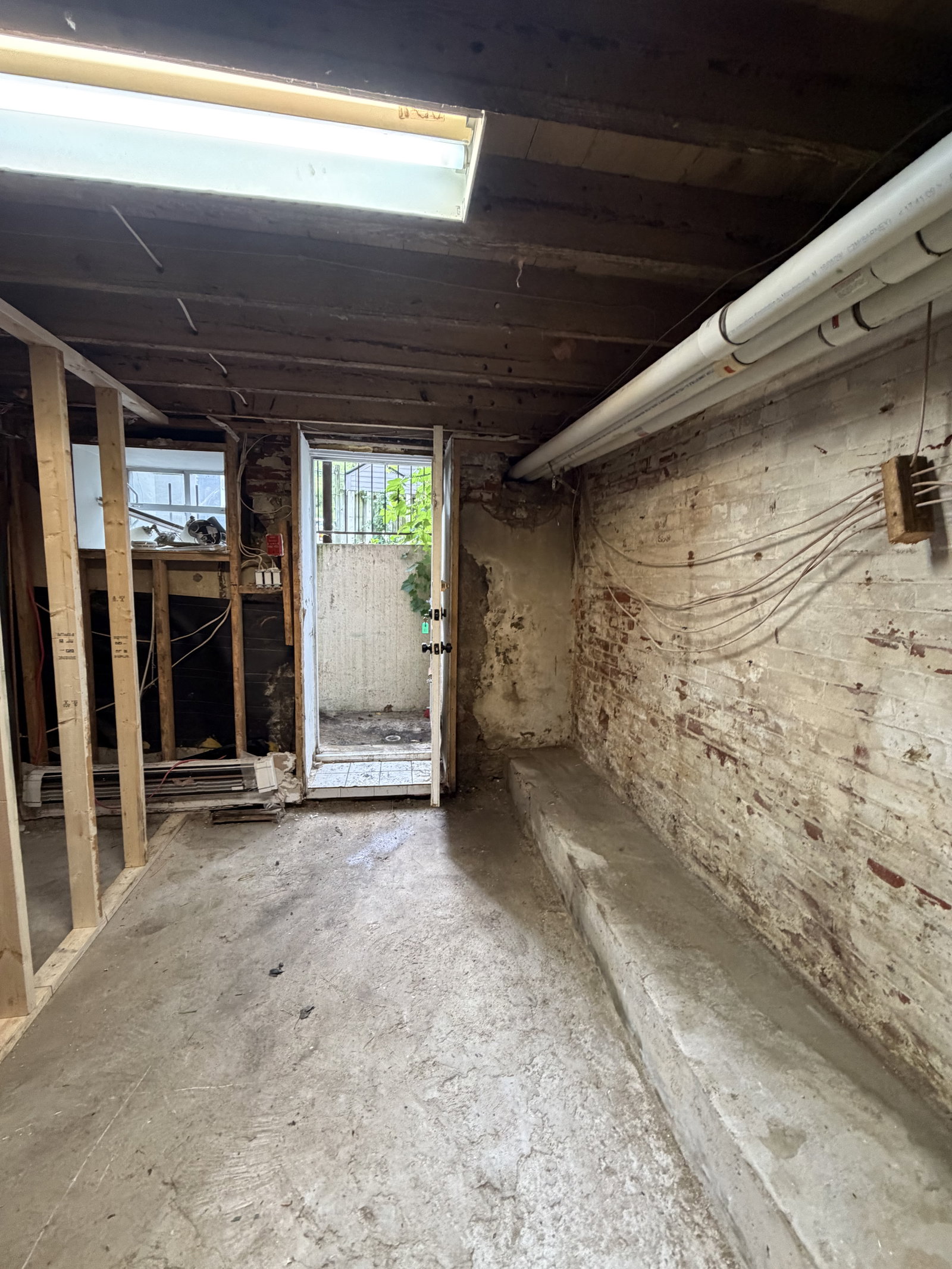 Dilapidated interior room with door.