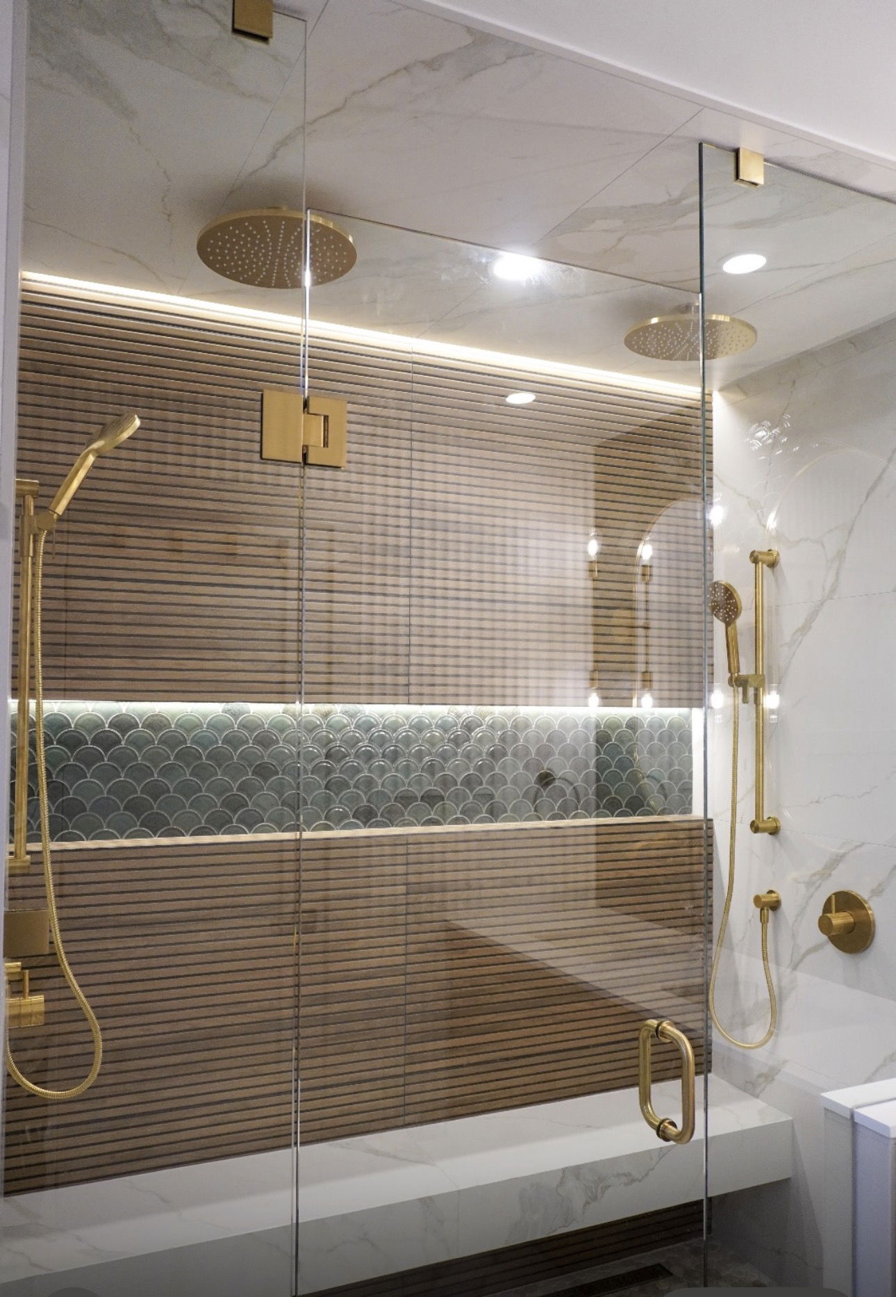 Custom walk-in shower with non-slip tiling and safety grab bars for aging in place.
