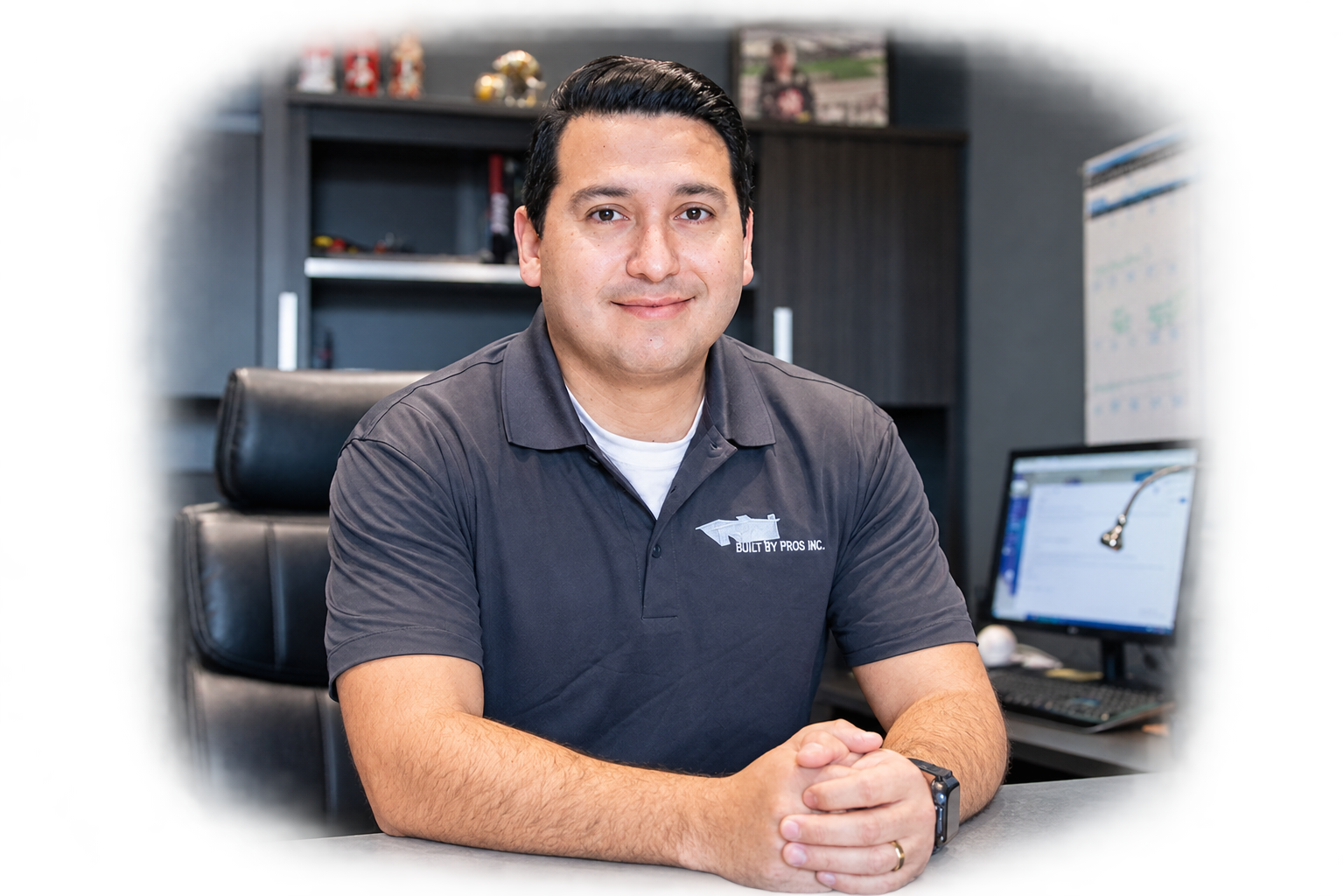 A professional man standing in a modern, renovated office setting in Oakville.