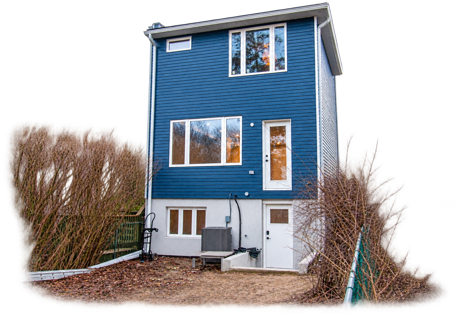 Renovated home exterior with blue siding and landscaped yard